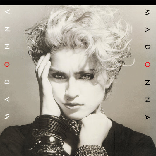 Album cover art for Madonna featuring a black and white close-up portrait of Madonna with stylized hair and text reading 'MADONNA' vertically along the sides.