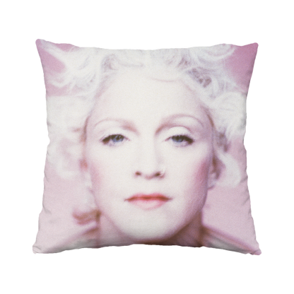 Pillow with a printed design of a face on a white background